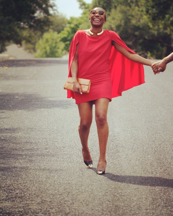pic of girl laughing and wearing red cape dress