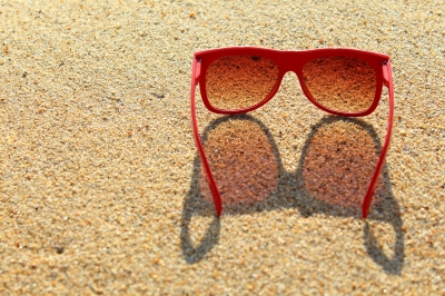 red sunglasses on the beach