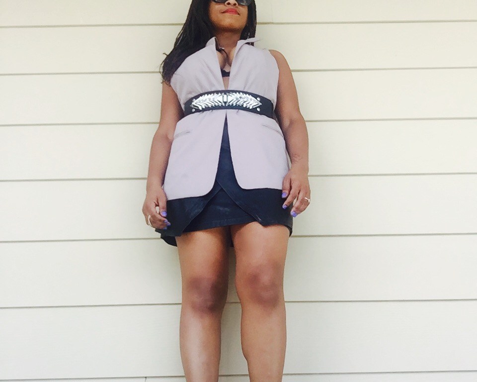 taupe vest, metal belt, black leather wrap skirt, silver heels