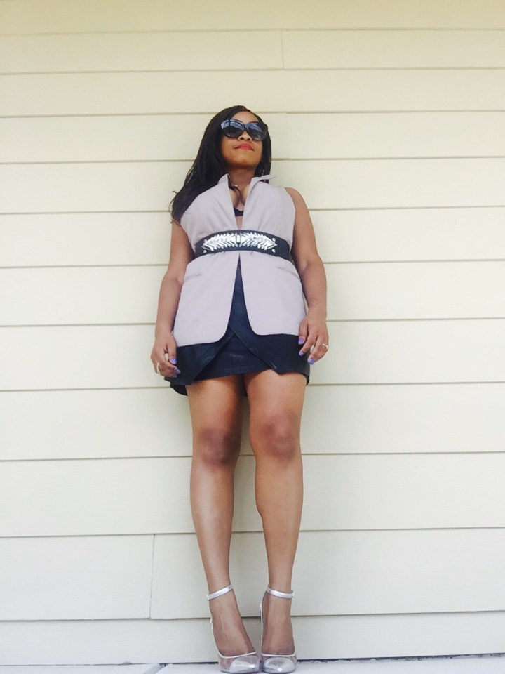 taupe vest, metal belt, black leather wrap skirt, silver heels