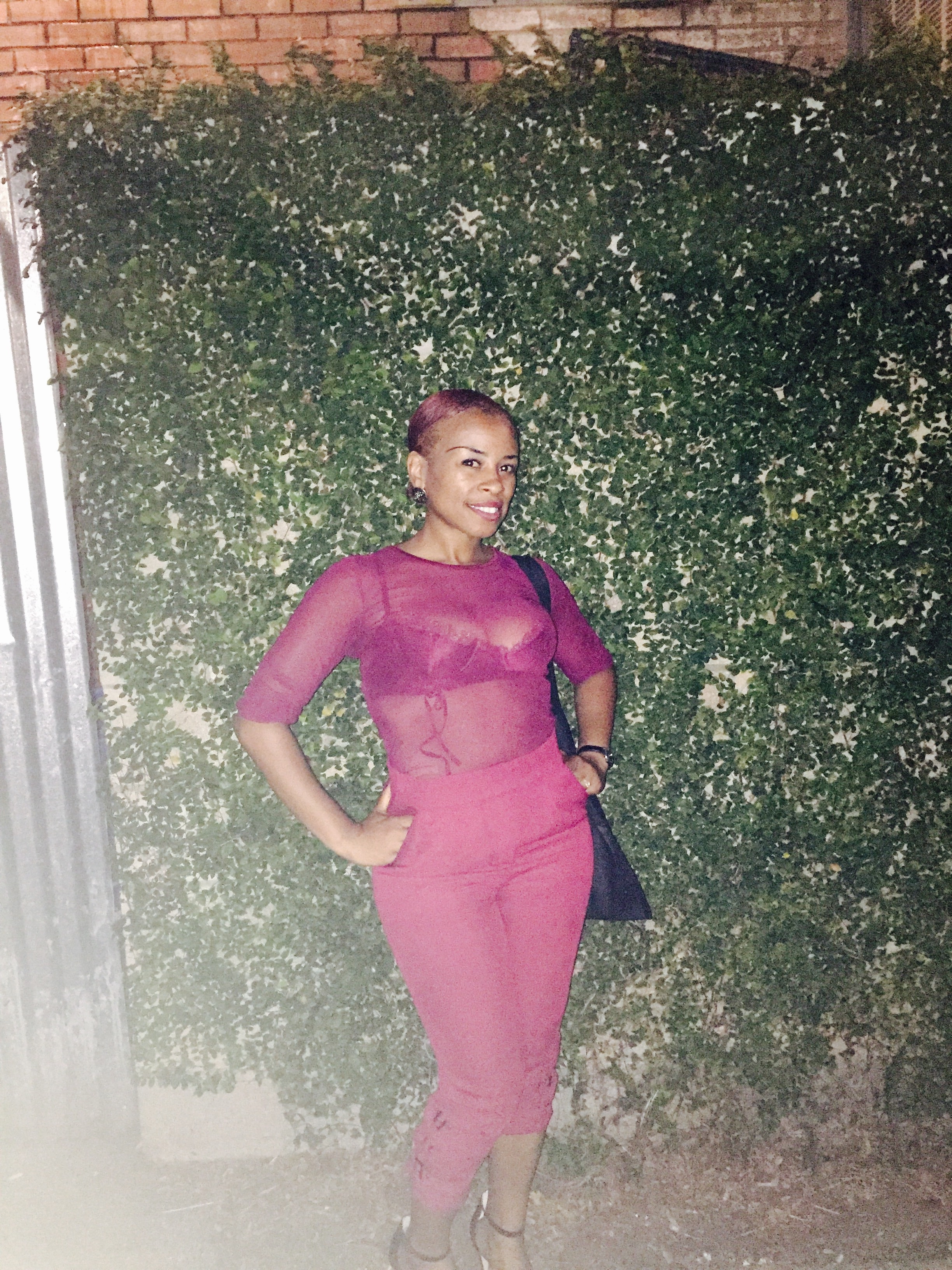 kristie wearing a burgundy trouser and burgundy sheer top blue labels boutique