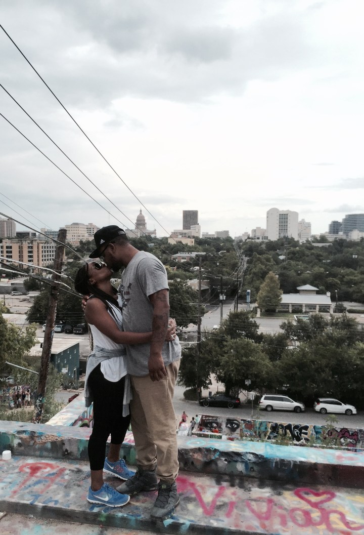 couple kissing on graffiti wall
