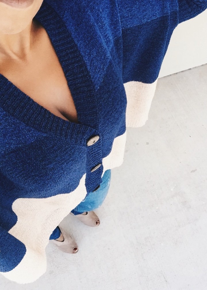 wearing color block sweater blue labels boutique
