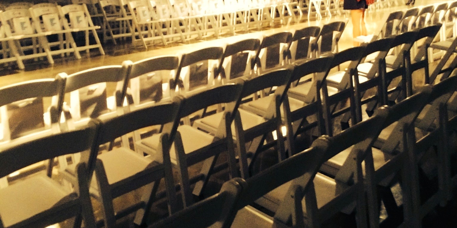 pic of empty runway with white chairs