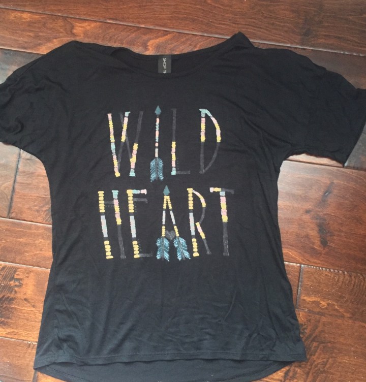 black tshirt with wild hear on the front in feathers blue labels boutique