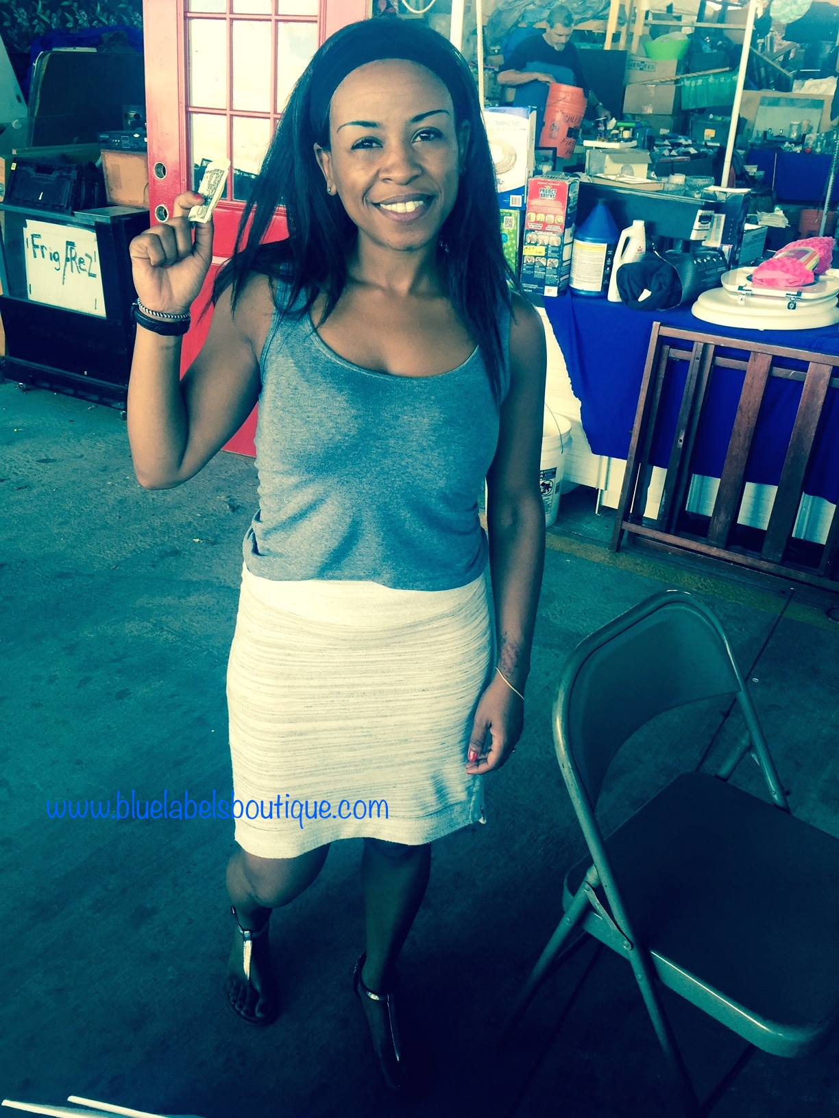 black woman holding money up at vendor show
