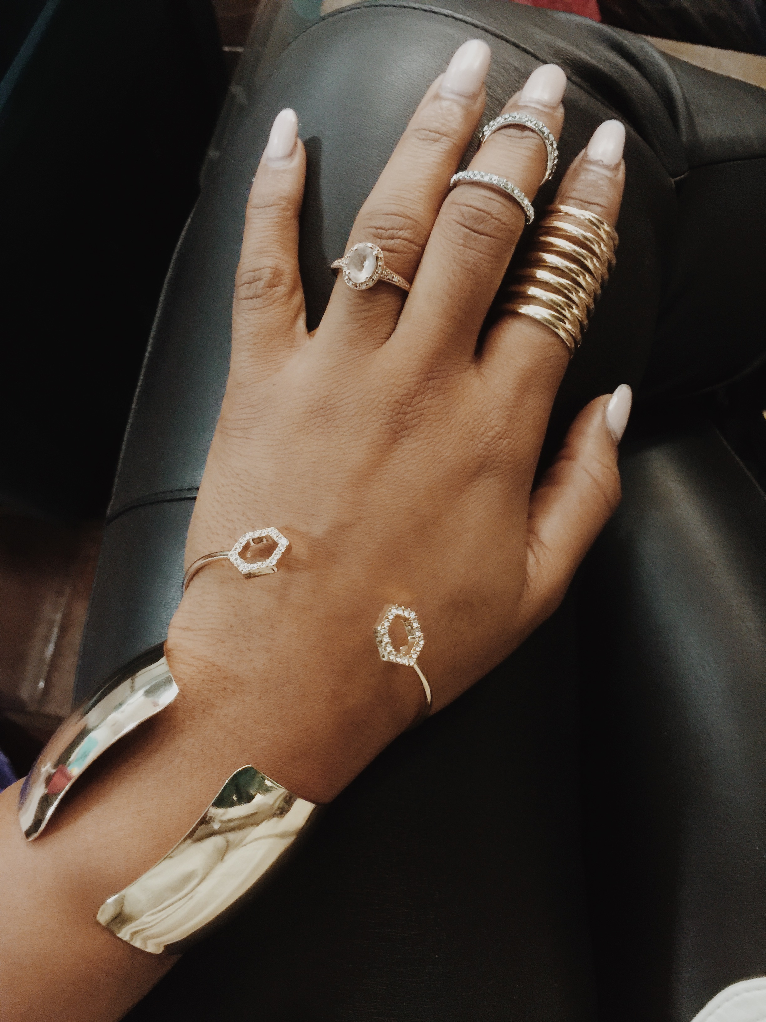 hand wearing gold stack rings