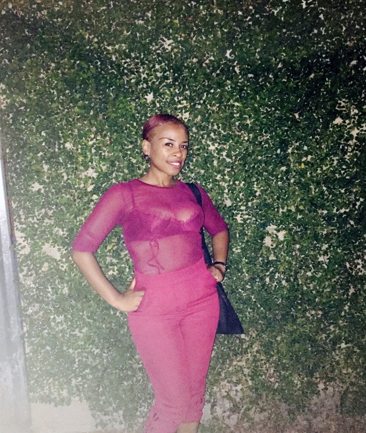 black women is burgundy top and trousers