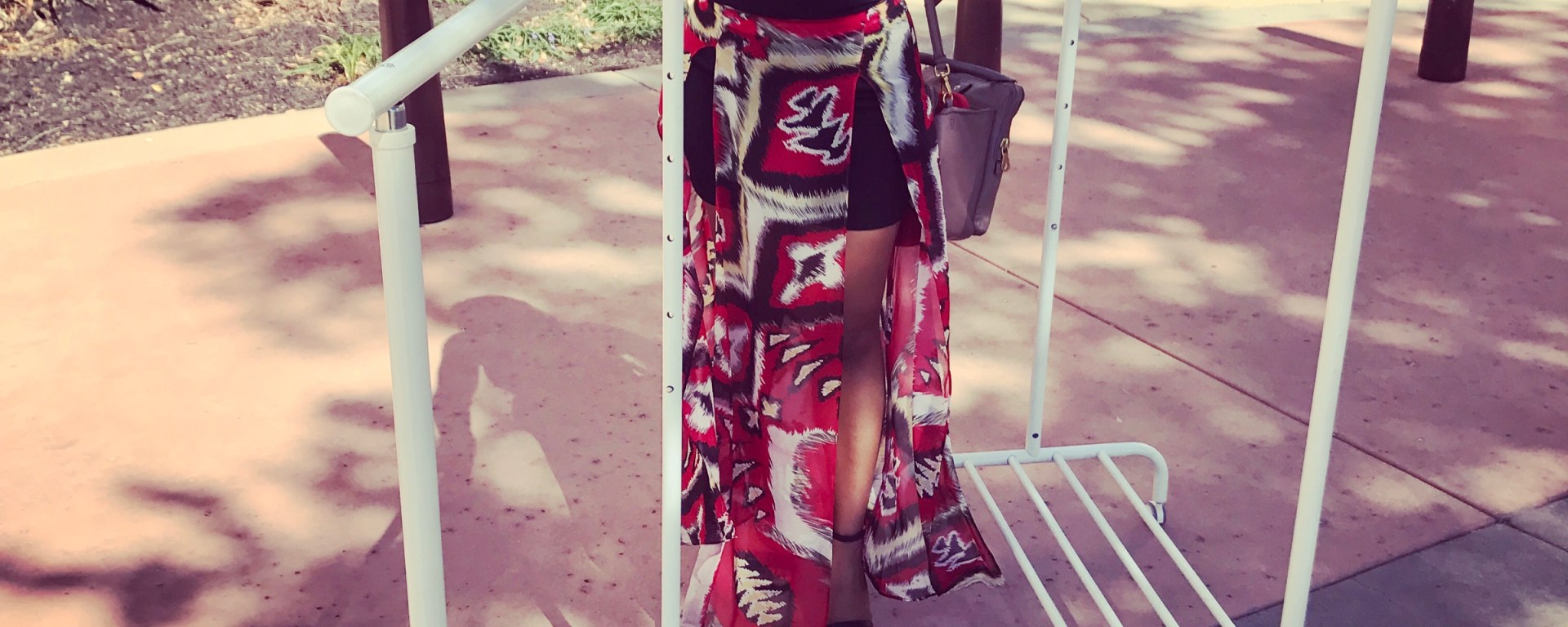 girl rolling clothing racks through mall