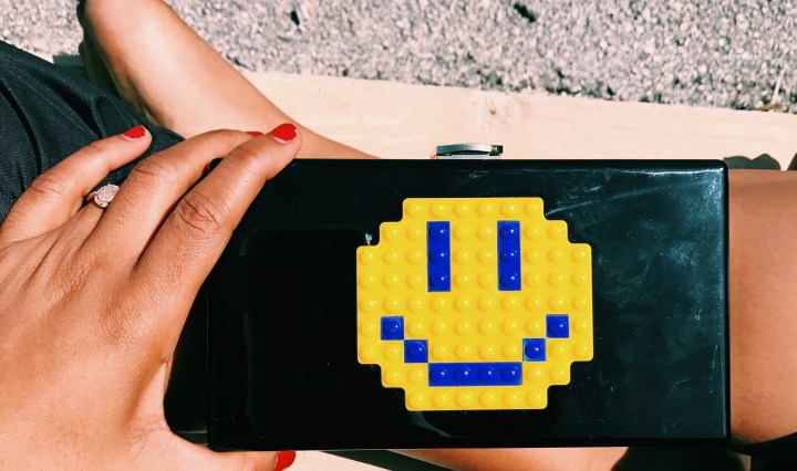 black clutch bag with smiley face blue labels boutique