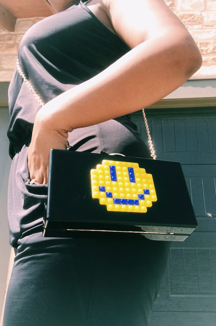 black clutch bag with smiley face blue labels boutique