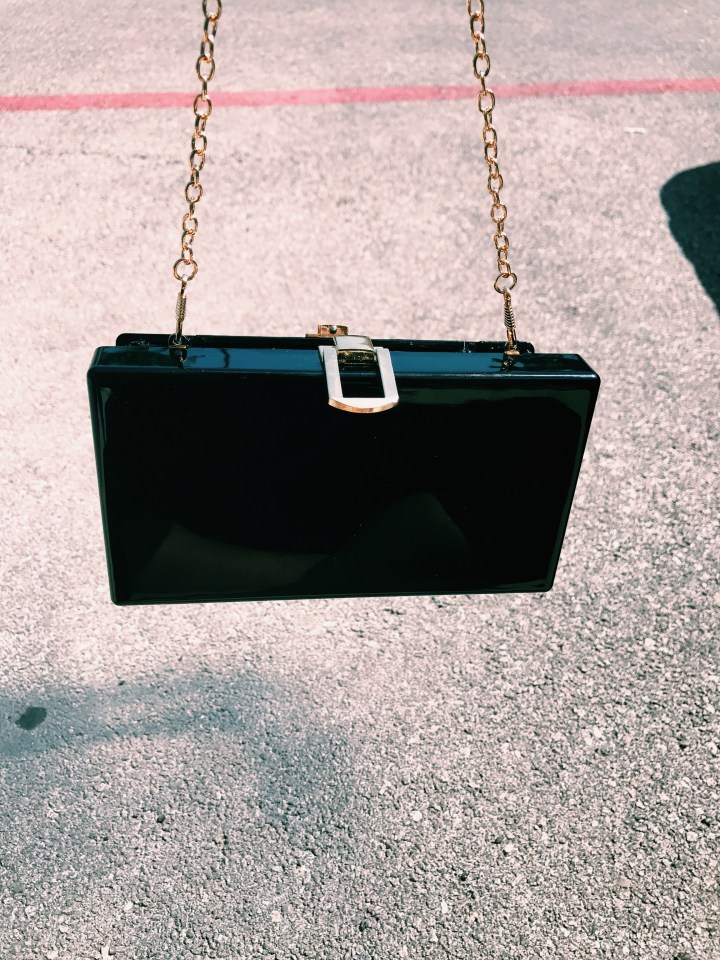 black clutch bag with smiley face blue labels boutique