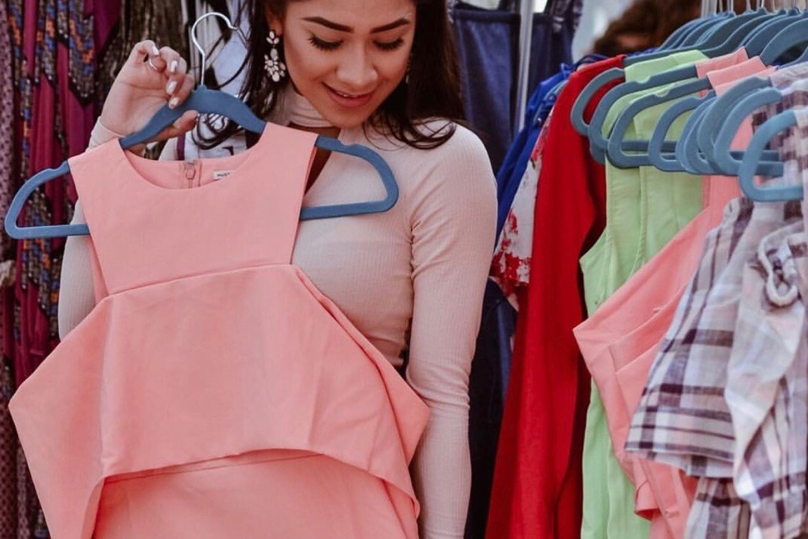 girl holding peach off the shoulder dress