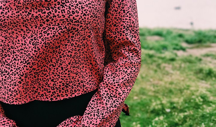 woman wearing pink black animal print blouse