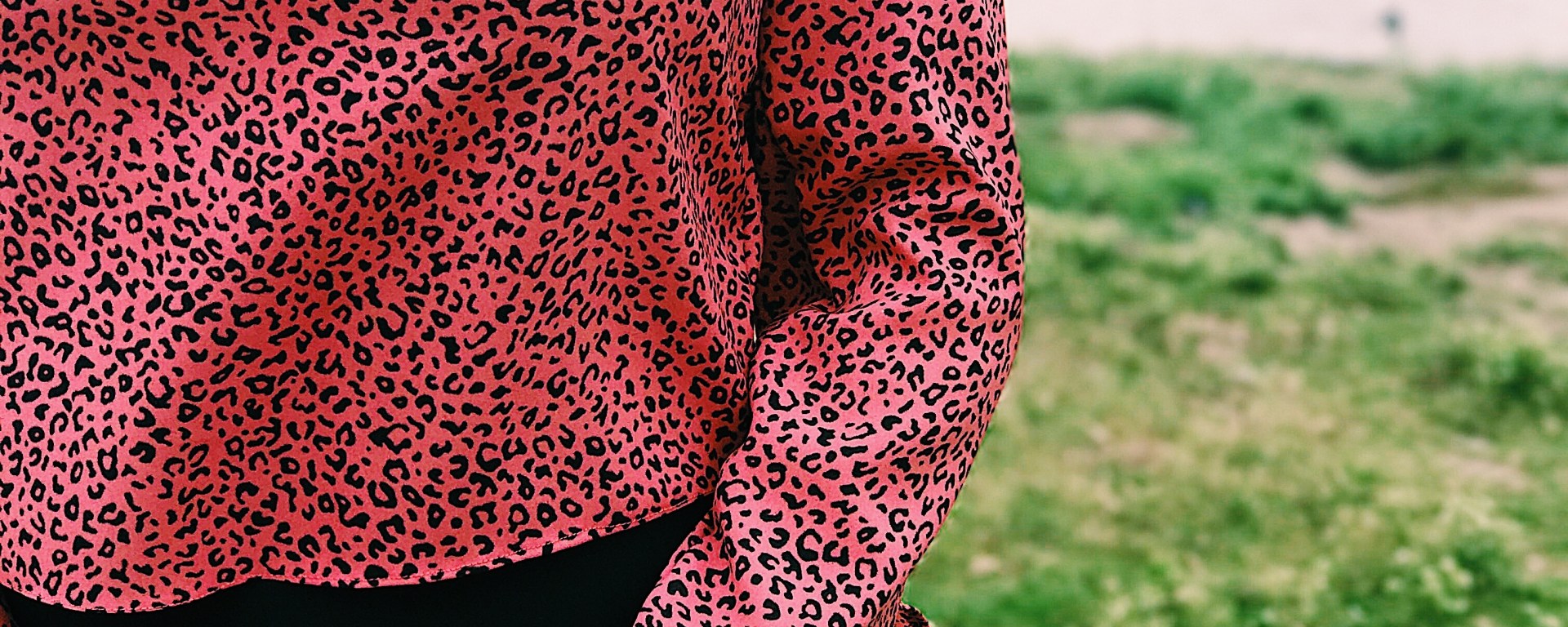 woman wearing pink black animal print blouse