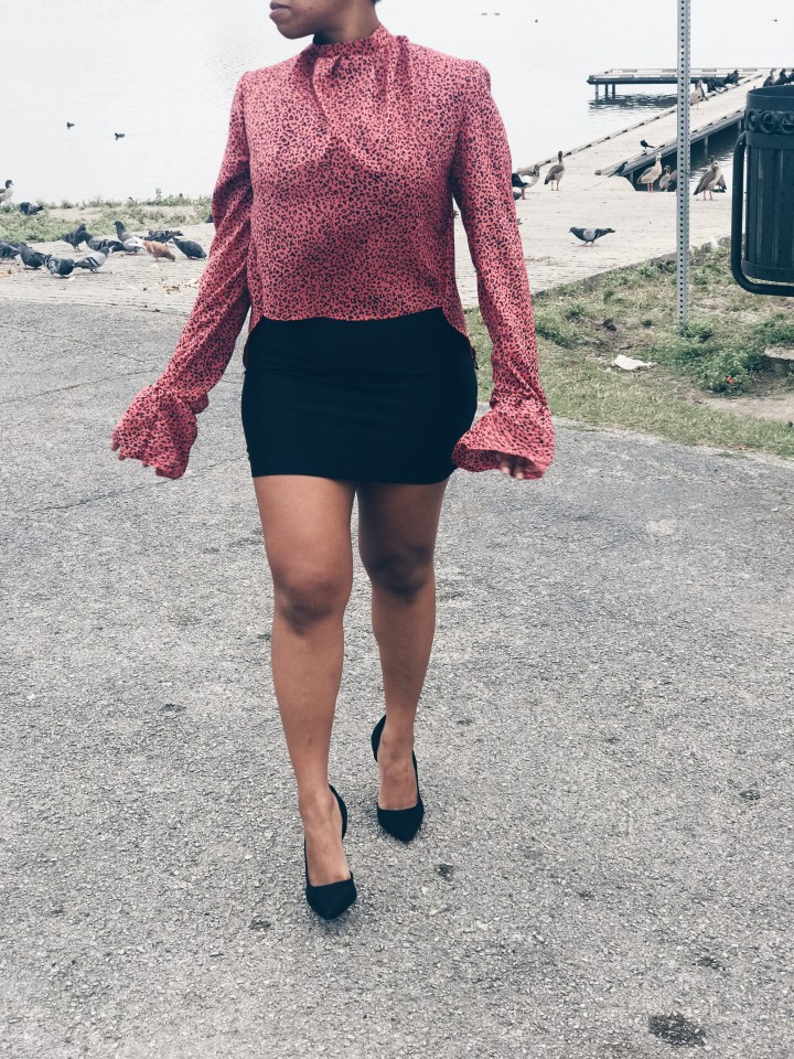 woman wearing pink black animal print blouse