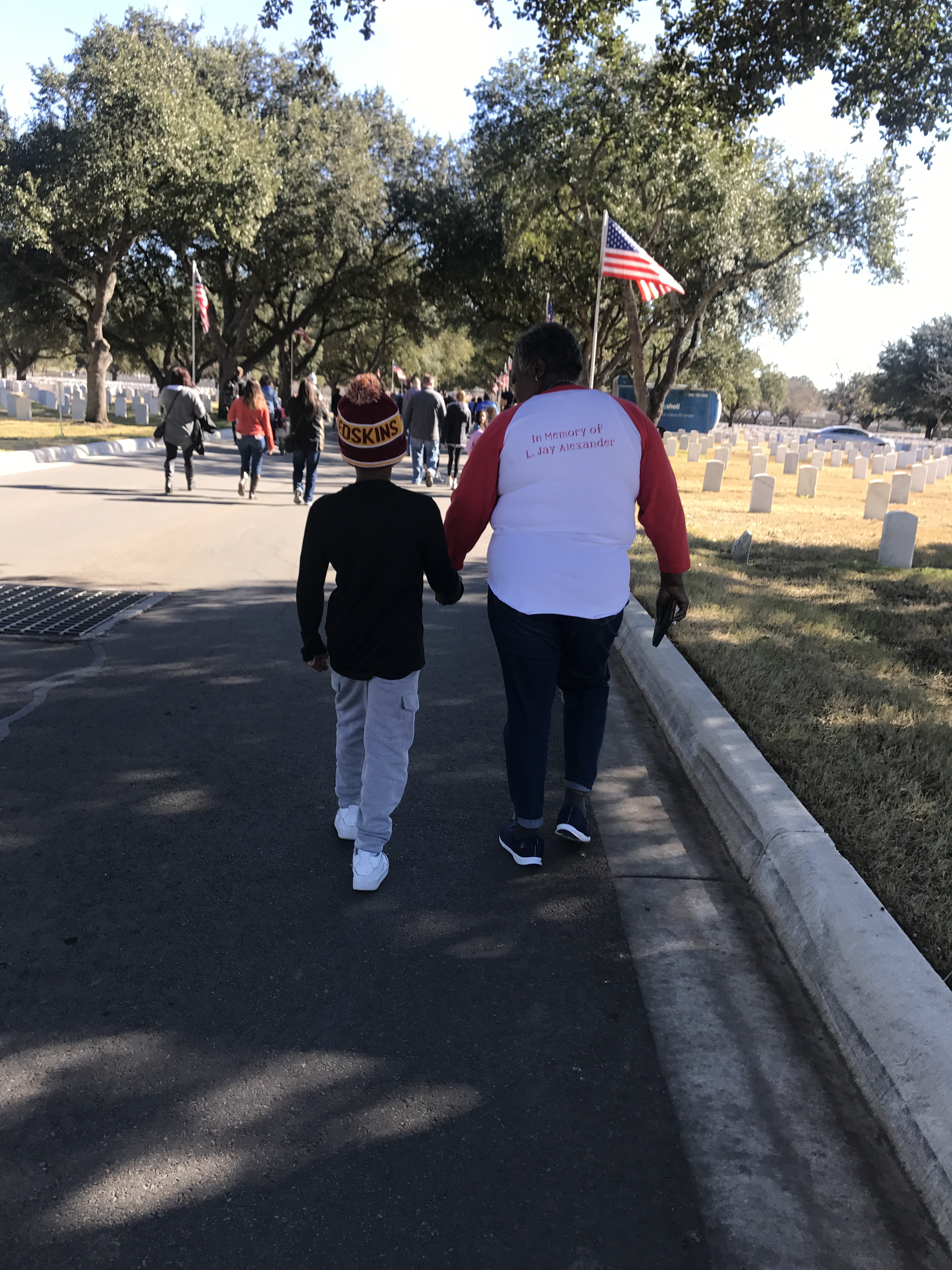 mama and nephew holding hands at cemetery 
