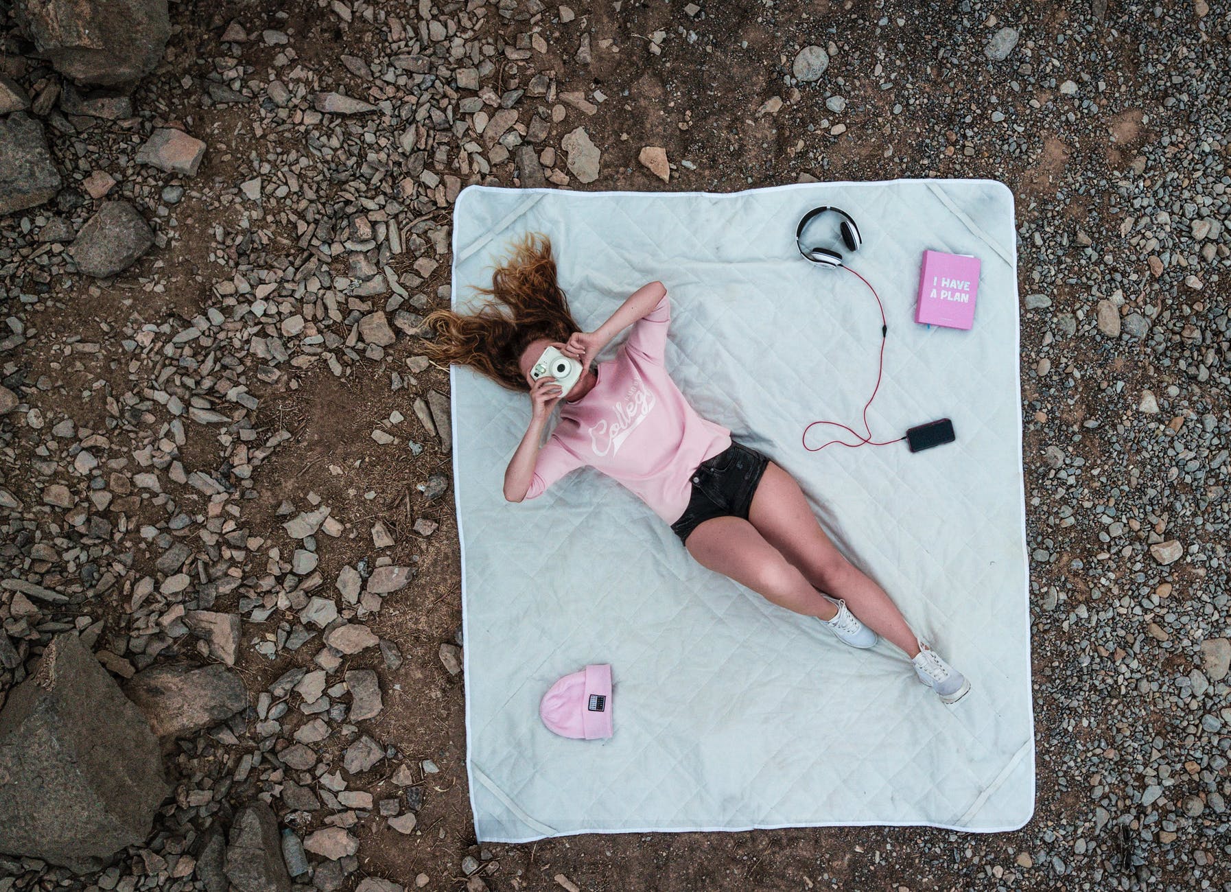 top view photo of woman lying on mattress