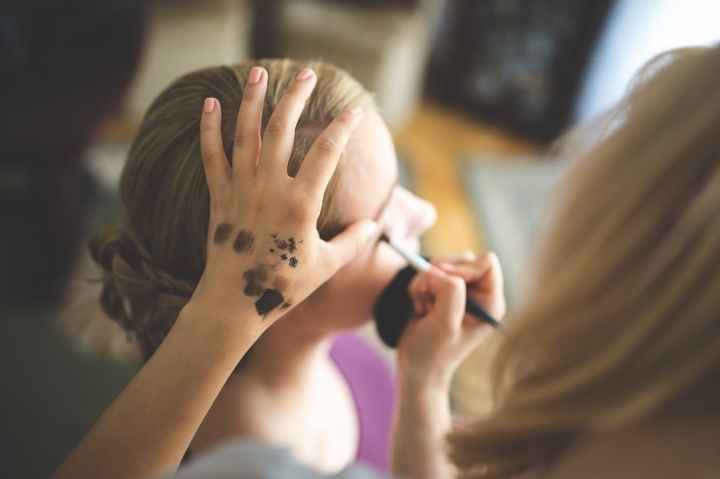 make up artist applying shadow to a woman