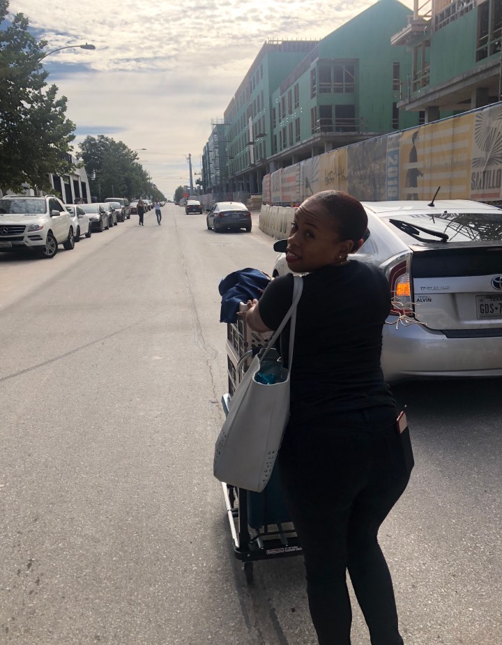 Boutique owner pushing a cart for pop up 