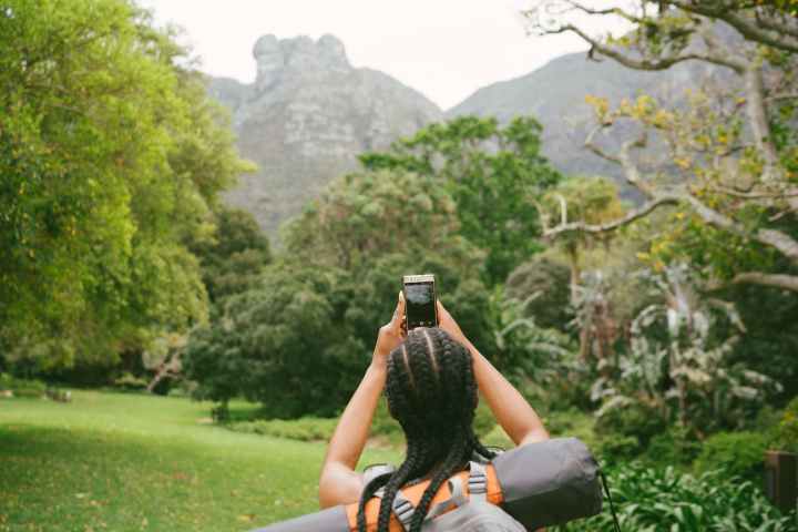 photo of woman taking picture of nature