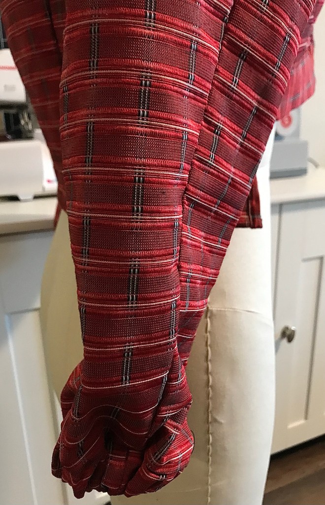 Sleeve of Red woman’s handmade jacket